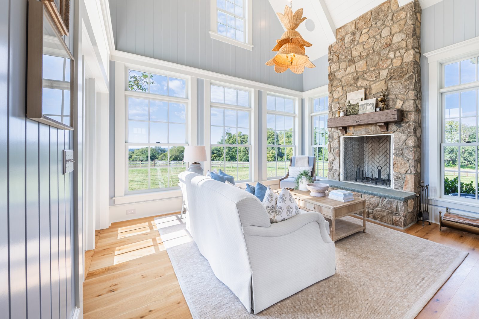 The sunroom with its stone fireplace