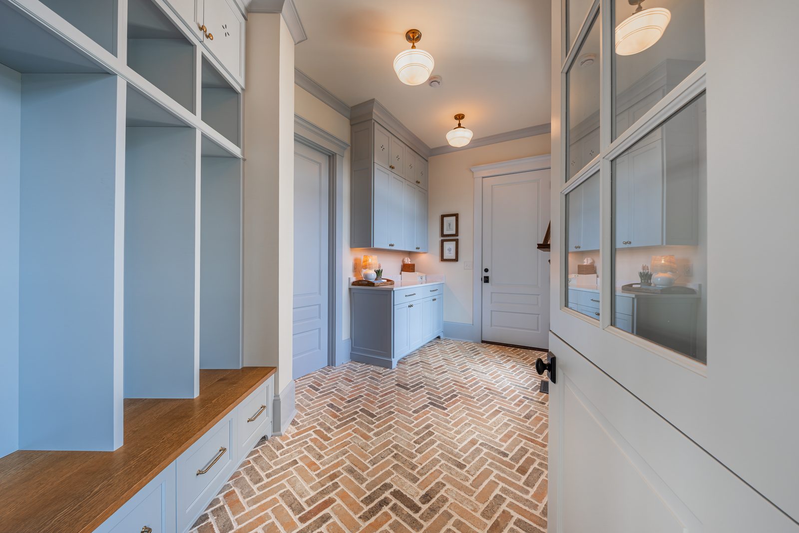 The mudroom with a herringbone brick floor