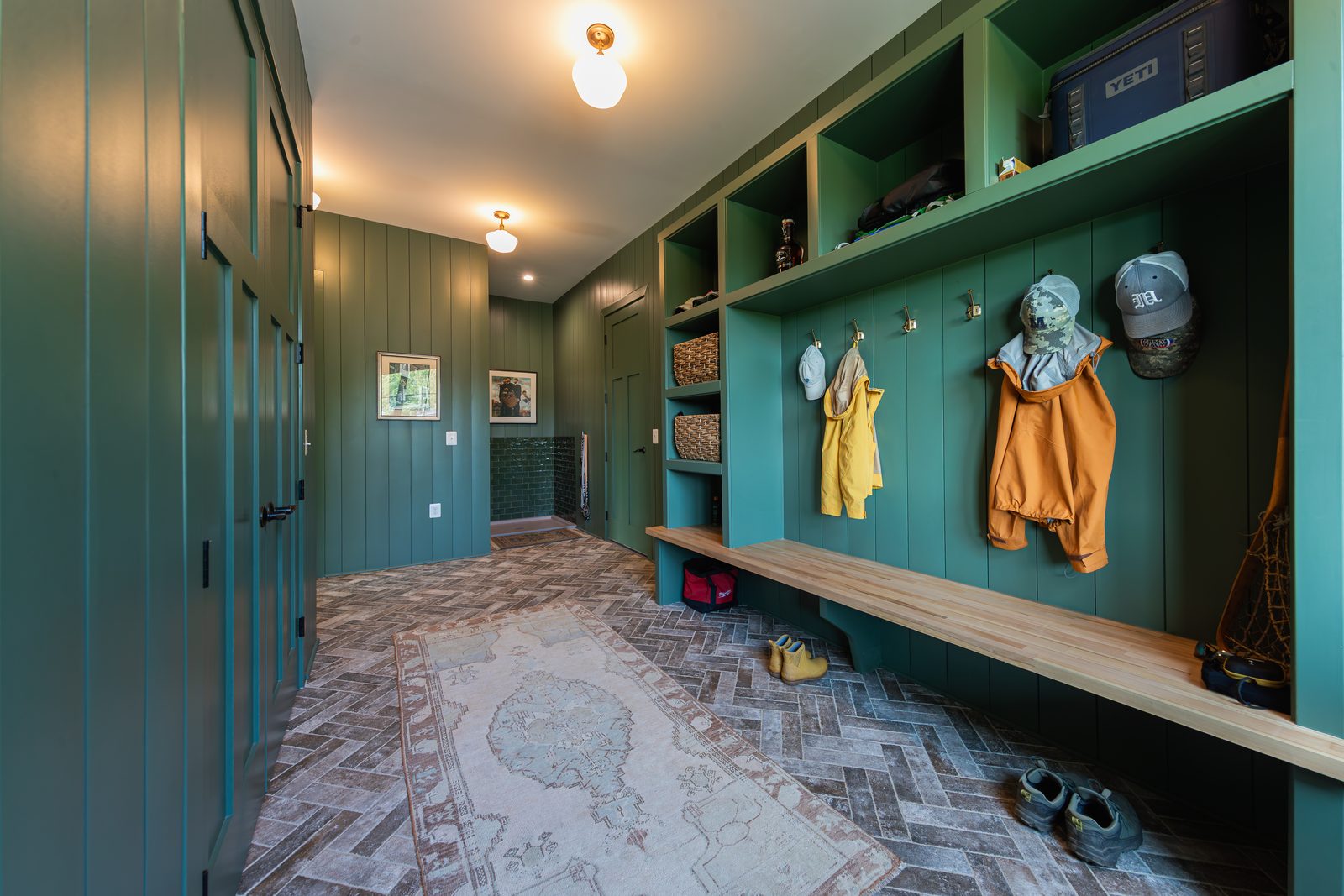 The green mudroom with built-in cubbies