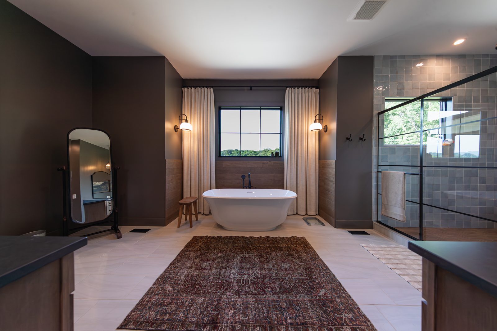 The primary bath, a freestanding tub under the window