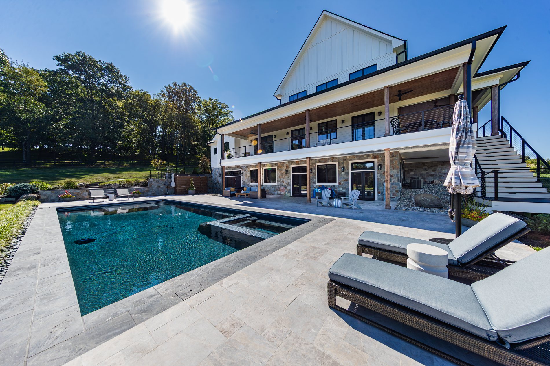 The rear elevation and pool of a finished Total Build home in Loudoun County