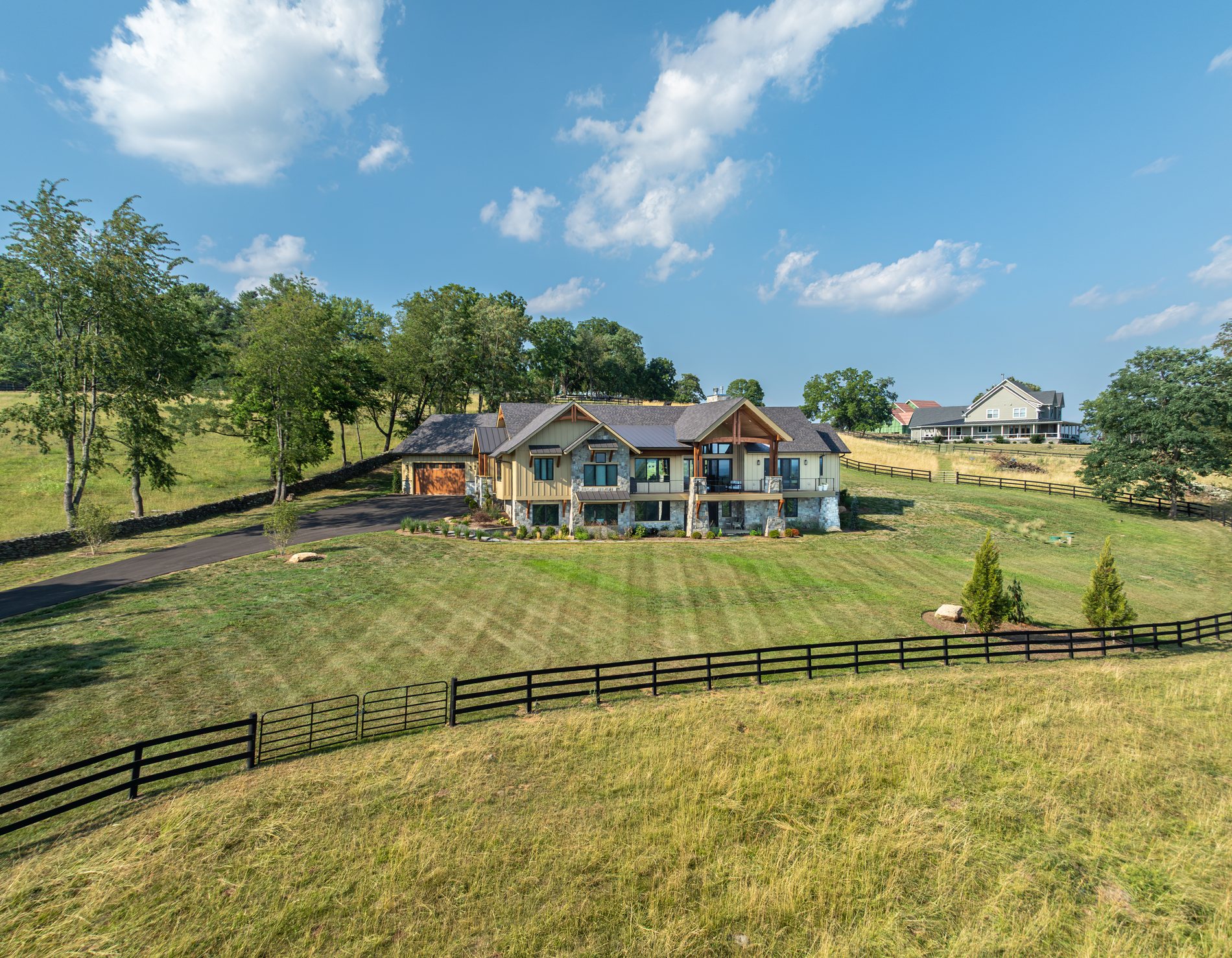 The Mountain Craftsman house from the air, in its pasture and fencing