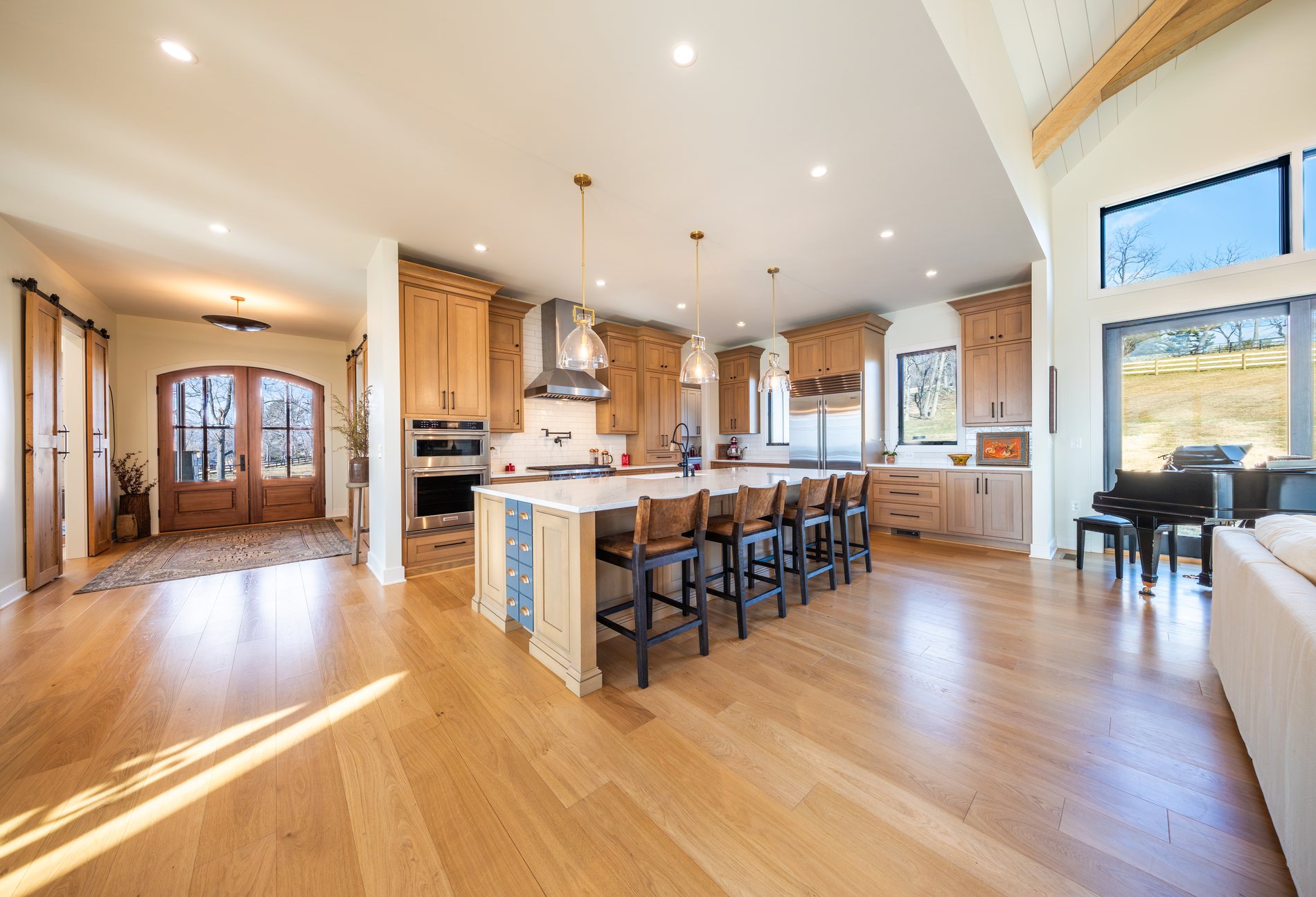 A custom kitchen with island and range in a Total Build home