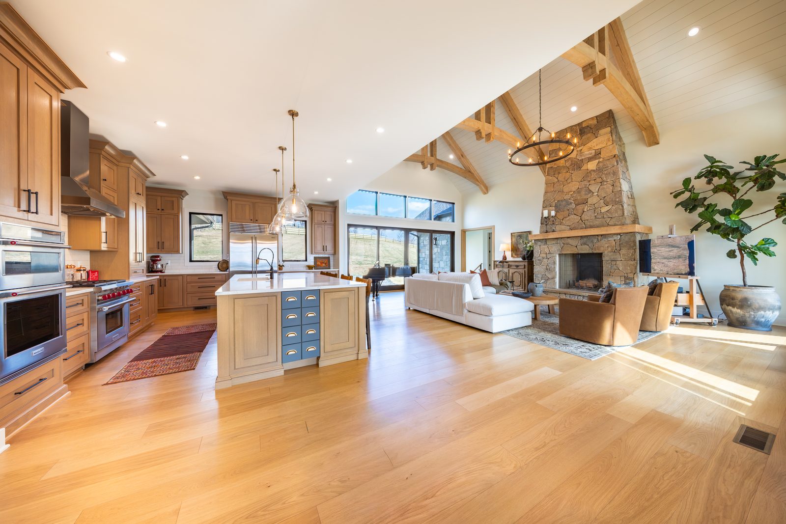 The open kitchen and great room under timber trusses