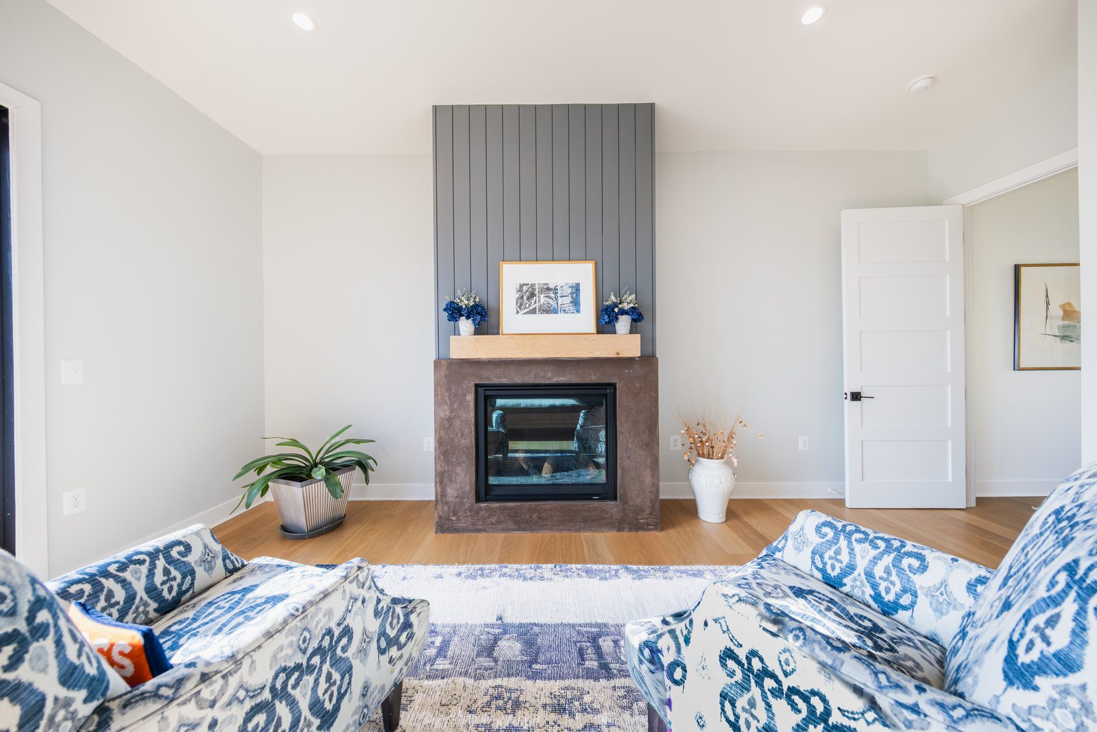 A sitting room with a tiled fireplace