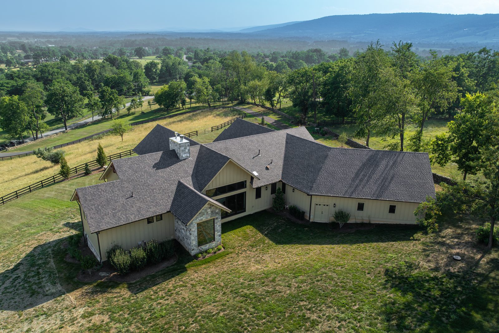 The Mountain Craftsman roofline from above, mountains beyond